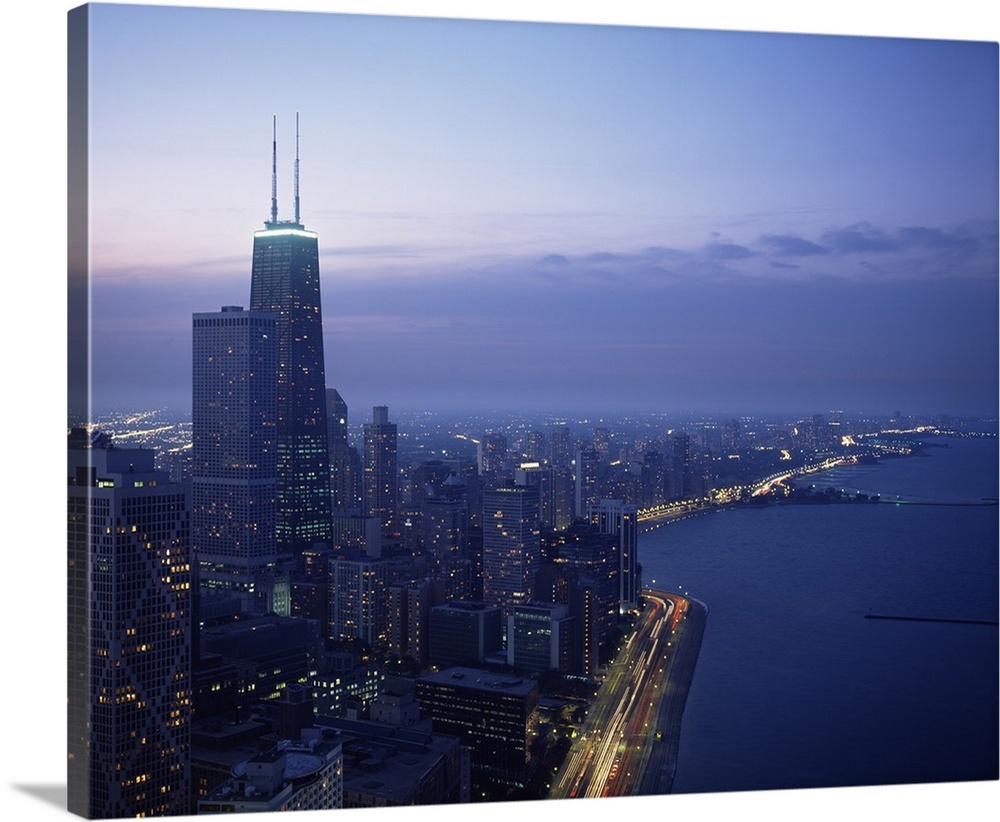 This large piece is a photograph taken of Chicago during dusk showing the busy city to the left and the lake to the right ...