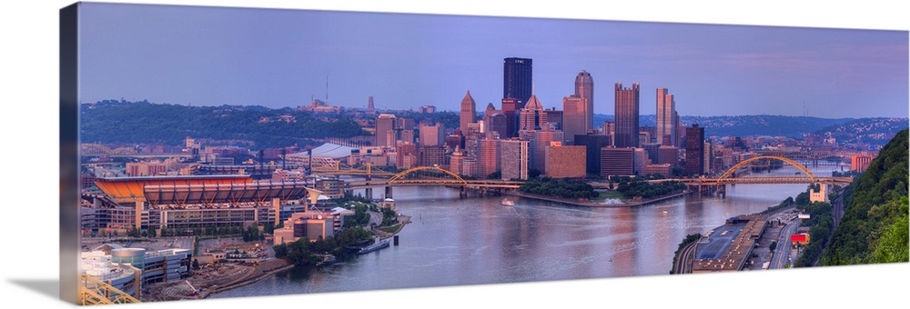 Panoramic, aerial photograph of the West side of the Pittsburgh skyline in Allegheny County, at sunset.