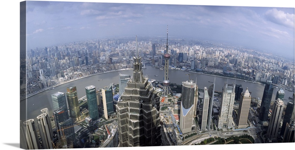 Landscape, high angle photograph of many buildings in the district of  Pudong, Shanghai, the Huangpu River runs through, b...