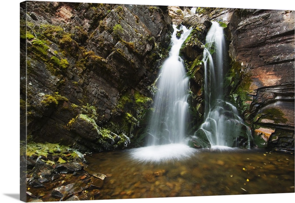 Photo on canvas of water falling from a rocky cliff into a pool of water in Montana.