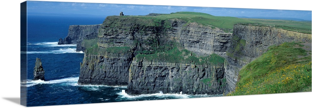 Panoramic photograph of the Cliffs of Moher County Clare in Ireland on a sunny day.