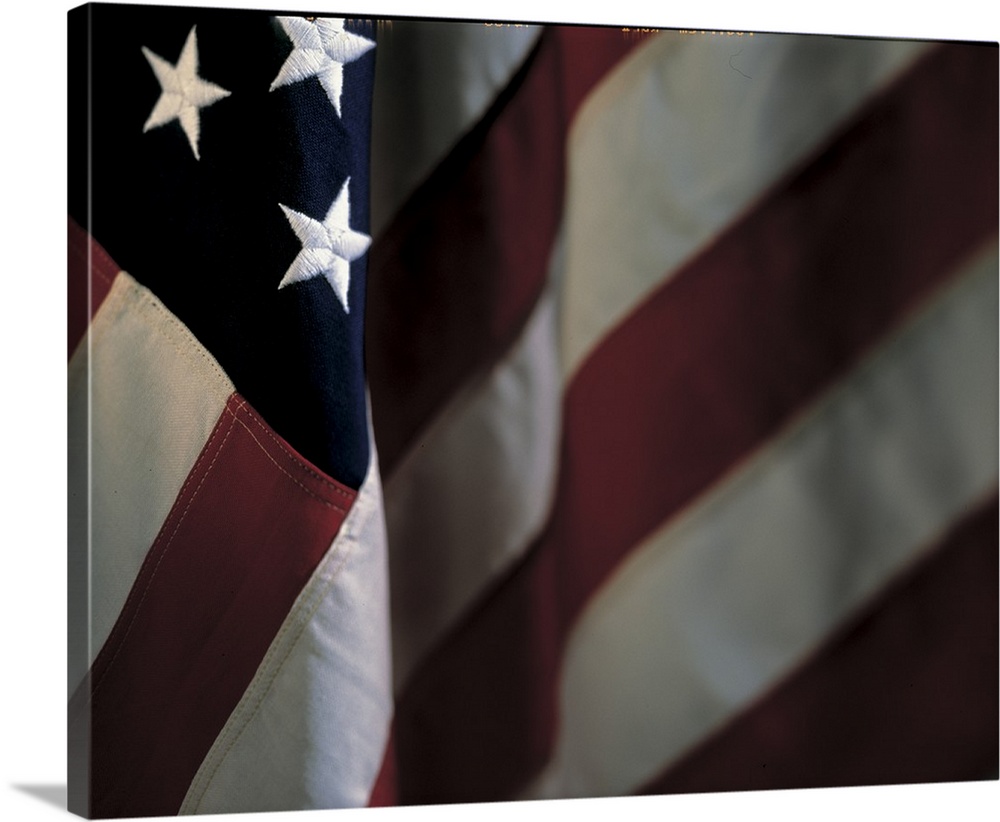 Oversized, close up landscape photograph of part of the stars and stripes of the American flag.