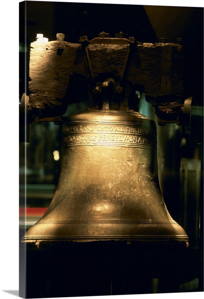 A large close up photograph of the liberty bell with a touch of sunlight hitting it.