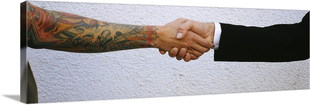 Man shaking hands with tatooed man, Germany