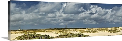 Clouds over the beach with California Lighthouse in the background, Aruba