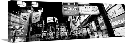 Commercial signboards lit up at night in a market, Japan