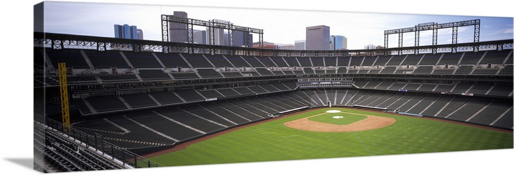 Panoramic, aerial photograph of Coors Baseball Field in Denver, Colorado.  A view of home plate surrounded by empty stands...