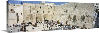 Crowd praying in front of a stone wall Wailing Wall Jerusalem Israel