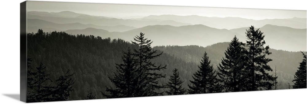 Panoramic monochromatic photograph displays a view overlooking the layered mountain ranges within a region of the Southeas...