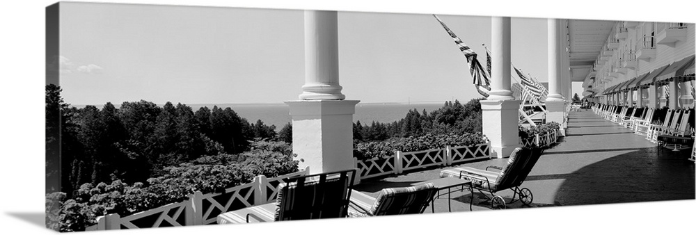 Giant landscape photograph looking down the outdoor balcony of the Grand Hotel as it overlooks the tree tops on Mackinac I...