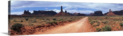 Dirt road through desert landscape with sandstone formations, Utah