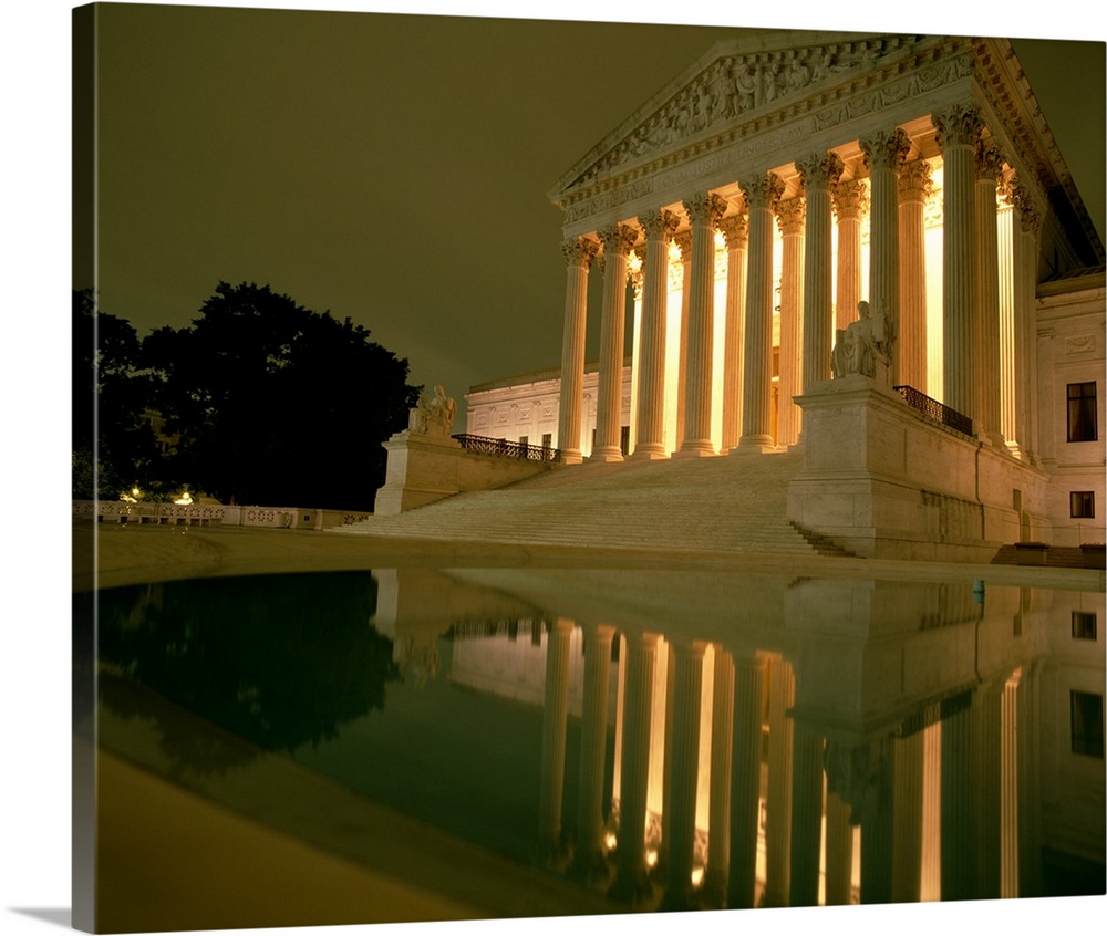 Photograph taken of the Supreme Court in the capital illuminated at night.
