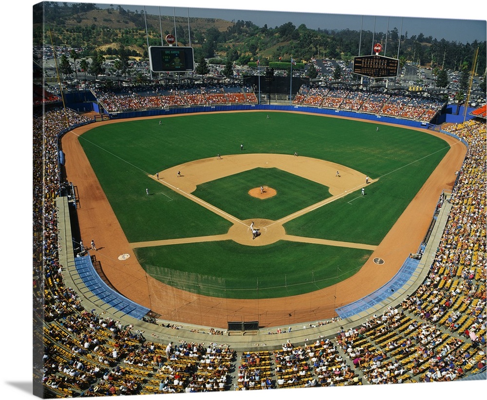 Landscape, aerial photograph of the stands packed at Dodger Stadium during a baseball game.