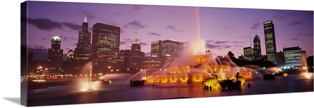 Panoramic photograph taken of Buckingham Fountain lit up at dusk as it sprays water in an intricate sequence.  Located In ...