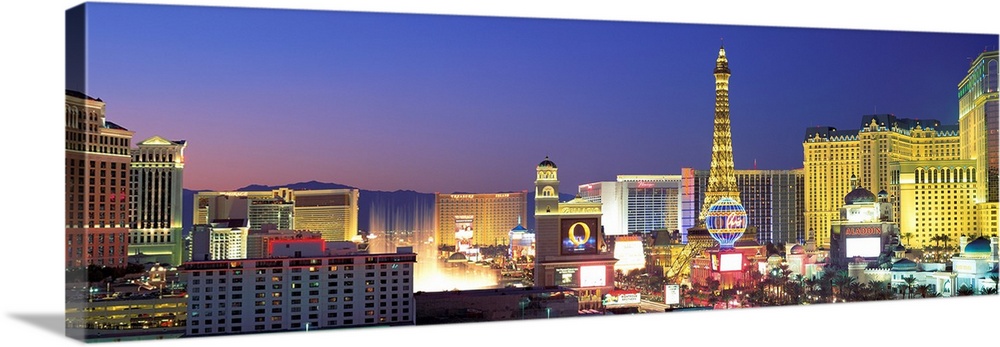 Panoramic photograph showcasing the bright neon lights of the busy strip in Las Vegas, Nevada at dusk.  Hotels and casinos...