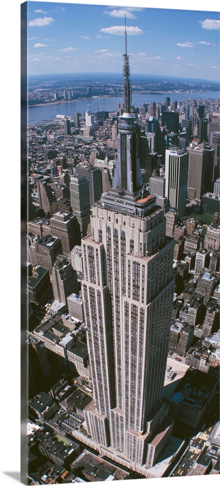 Panoramic photograph taken from an aerial view focuses on a landmark skyscraper found within Manhattan as it overlooks the...