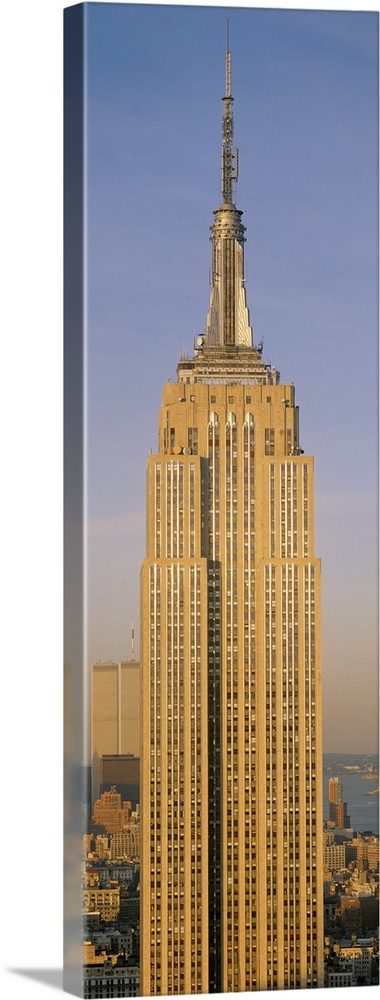A tall panoramic piece of just the Empire State Building with the sun hitting the side that was pictured.