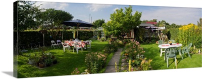 Empty chair and tables in a garden, Aalborg, Denmark