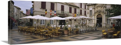 Empty chairs and tables at a sidewalk cafe, Avignon, Vaucluse, Provence-Alpes-Cote D'azur, France