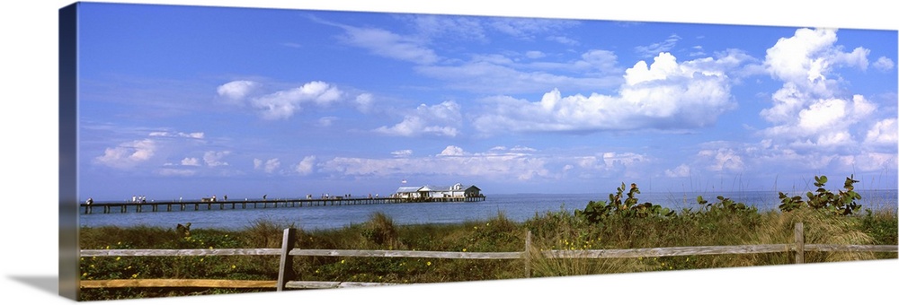 Fence on the beach with a pier in the background, Anna Maria Island City Pier, Tampa Bay, Gulf of Mexico, Anna Maria Islan...