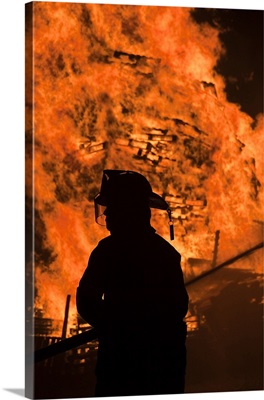 Fireman controlling flames, Fourth Of July Bonfire, Rockport, Cape Ann, Massachusetts