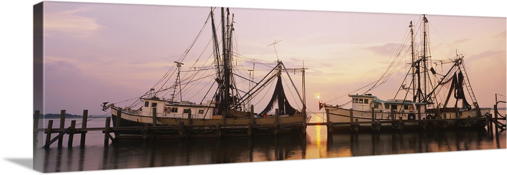 Wide angle photograph of two large fishing boats anchored alongside a dock in the Amelia River, at Fernandina Beach, Florida.