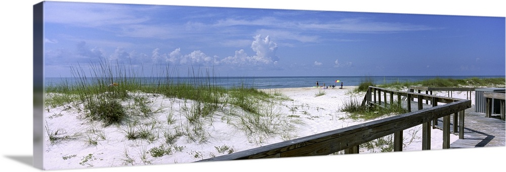 This wall art is a panoramic canvas of a boardwalk through the dunes to a sandy Atlantic coast beach.