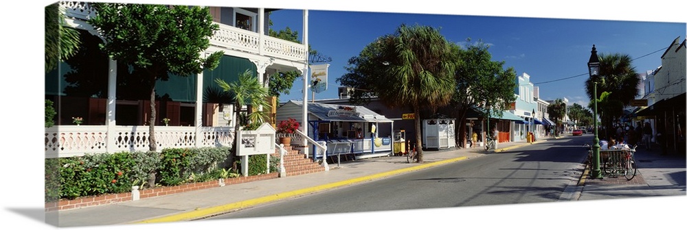 Panoramic photograph of street lined with shops in southern beach town.