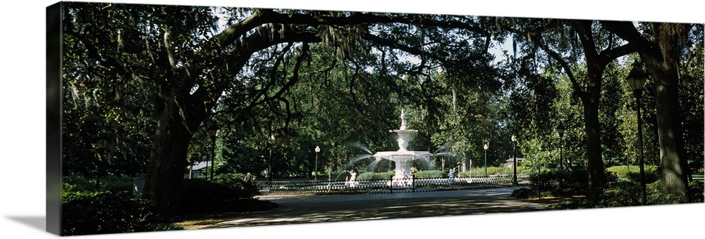 In the center of a park surrounded by landscape gardens and oak trees draped with Spanish moss this panoramic wall art cap...