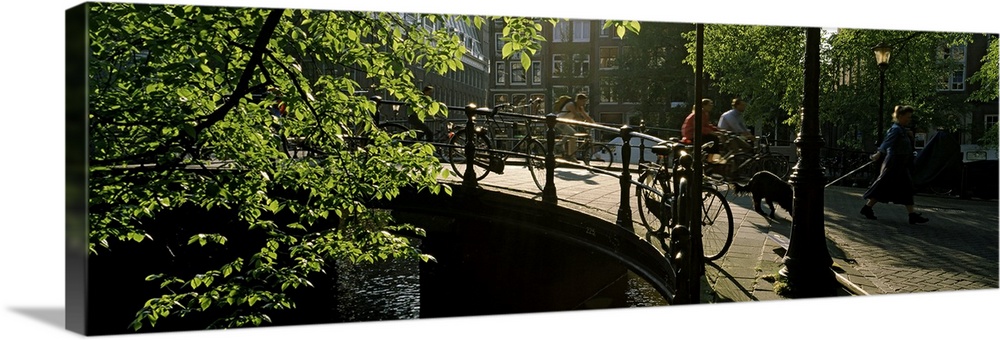 Four people crossing a bridge, Amsterdam, Netherlands