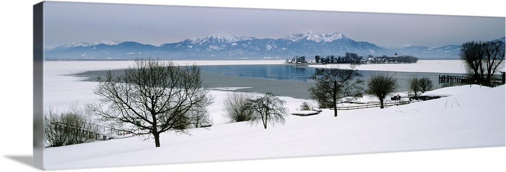Frozen lake in front of snowcapped mountains, Chiemsee, Bavaria, Germany