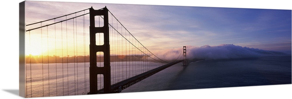 The Golden Gate Bridge is photographed in panoramic view looking from one end down to the other where there is a large clo...