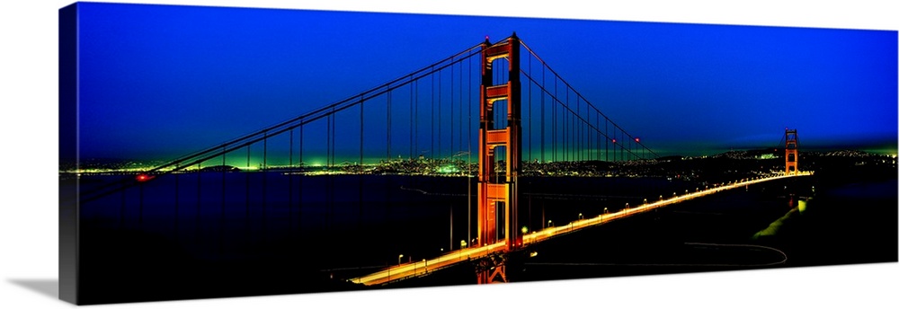 The Golden Gate Bridge and California coast lit up at night.