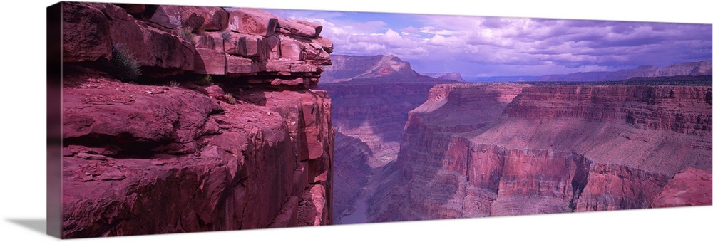 Panoramic photograph displays a look down the stretch of a famous chasm in the Western United States.  At the bottom of th...