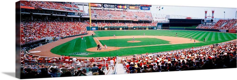 A crowded baseball stadium photograph from near home plate on a panoramic canvas.