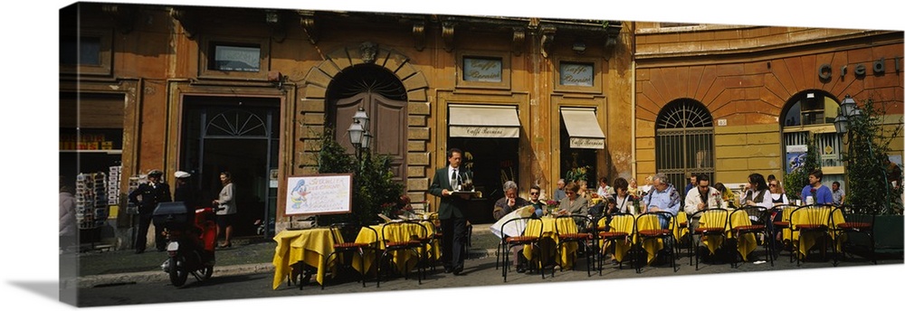 A panoramic view of diners sitting outside a restaurant in Italy.
