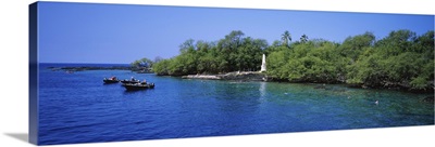Group of people boating besides a monument, Captain Cook Monument, Kealakekua Bay, Hawaii