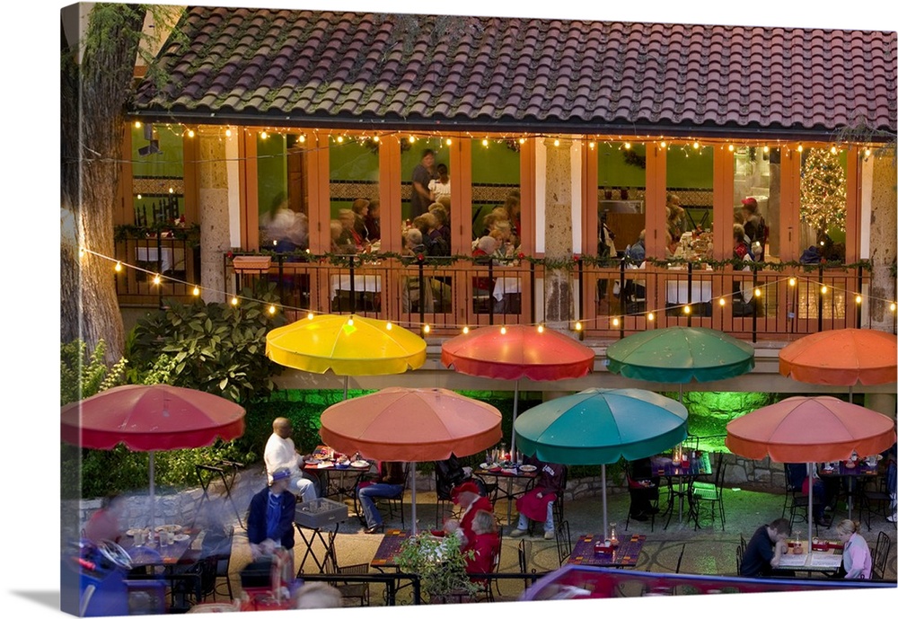 Group of people in a restaurant lit up at dusk, San Antonio, Texas