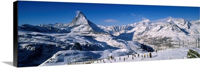 Group of people skiing near a snow covered mountain, Matterhorn, Switzerland