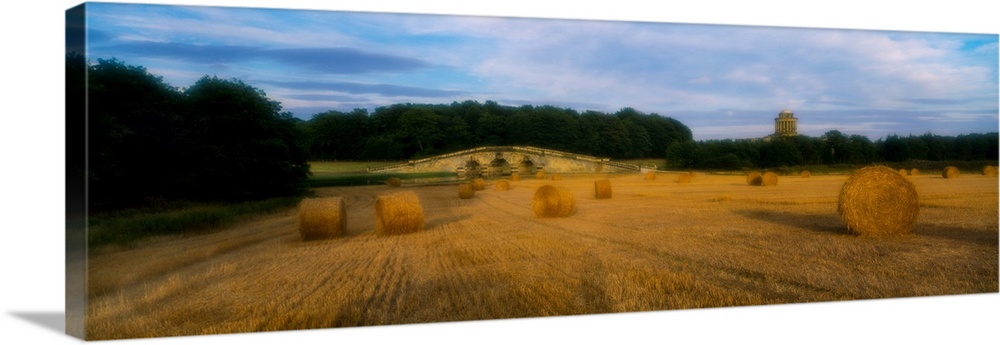 Hay bales in a field, new river bridge, howard mausoleum, castle howard, north yorkshire, england.