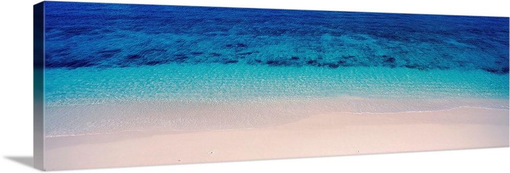 Panoramic aerial photograph of vibrant, clear blue waters along the sandy shoreline of Veidomoni Beach, in the Mamanuca Is...