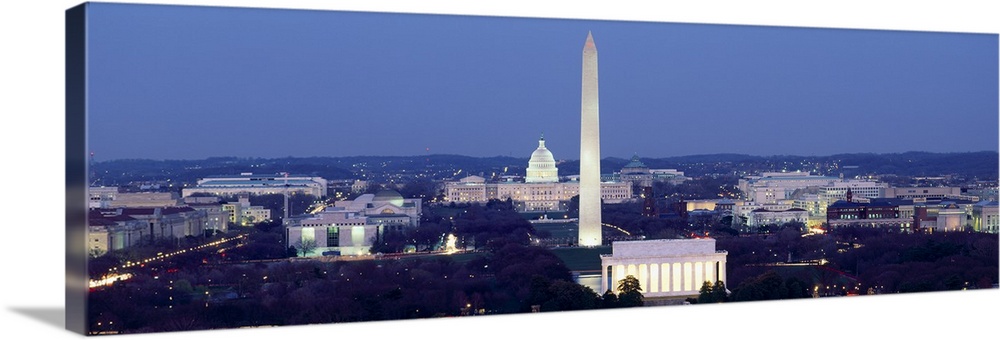 Panoramic photograph of the United States capital at dusk, showing several landmarks including the Washington Monument, th...