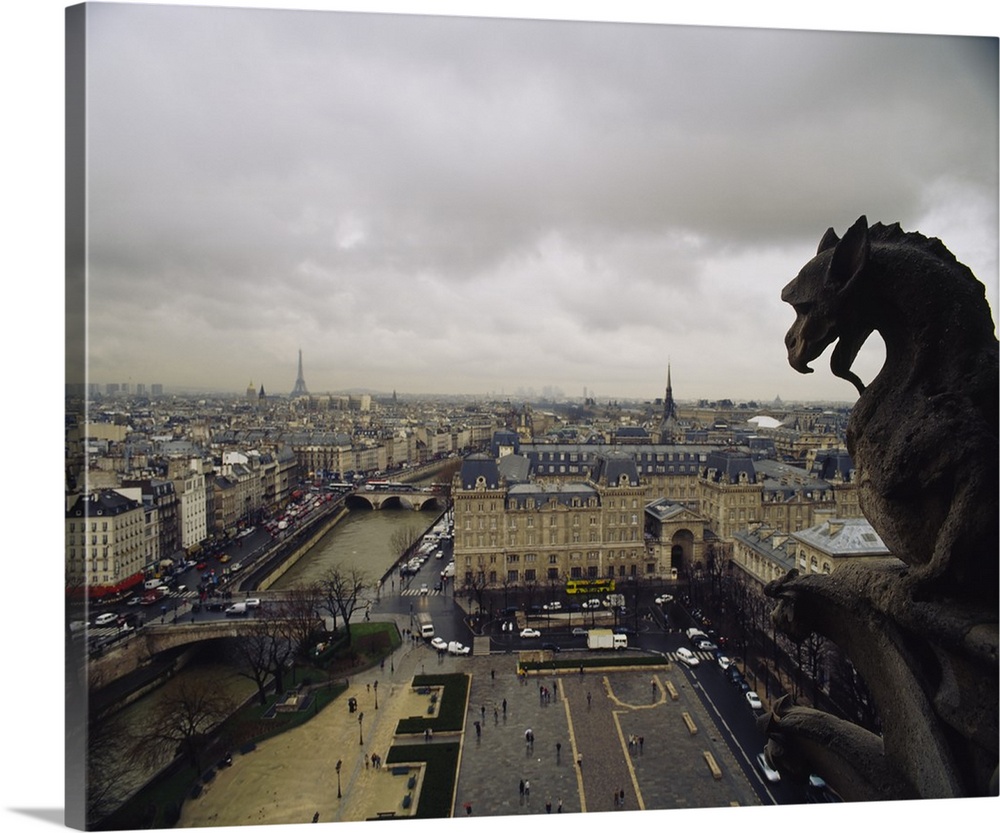 Horizontal, high angle photograph on a big canvas, looking past a gargoyle from the top of Notre Dame Cathedral, over the ...