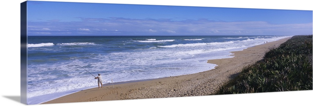 High angle view of a person fishing on the beach, Playalinda Beach, Canaveral National Seashore, Atlantic Ocean, Titusvill...