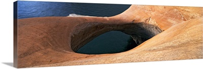 High angle view of a pothole arch at a lakeside, Lake Powell, Utah