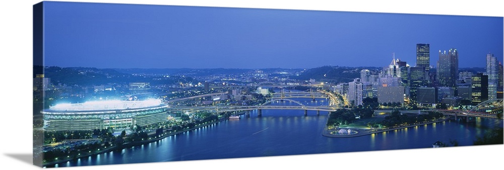 Panoramic photograph taken from an aerial view overlooking a busy city that sits next to the Ohio, Allegheny, and Monogahe...