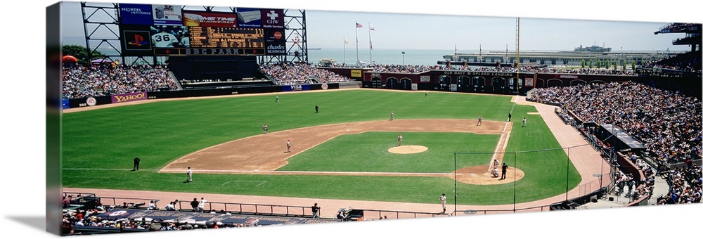 This decorative wall art is a panoramic canvas of a baseball stadium in the middle of a game.