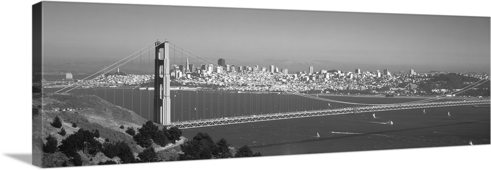Panoramic photograph of iconic west coast city overpass with city skyline in the distance on a foggy morning.  There are b...