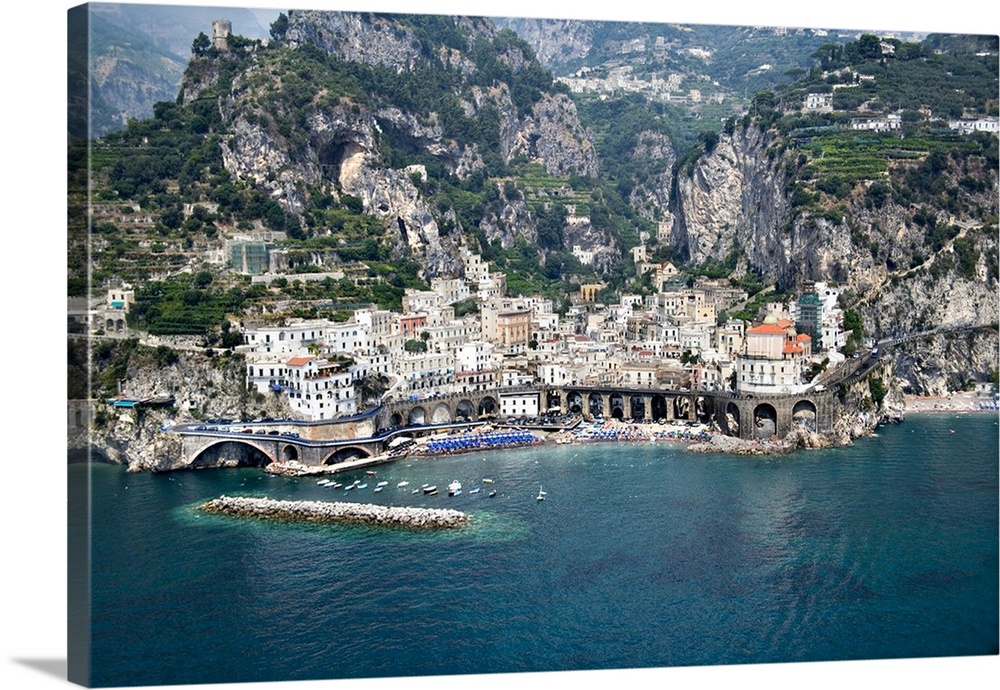 This decorative wall art is an aerial photograph of an Italian village and harbor build into steep costal hills.
