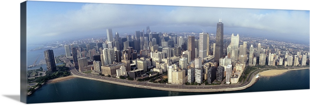 Panoramic photograph of cityscape and waterfront under a cloudy sky.